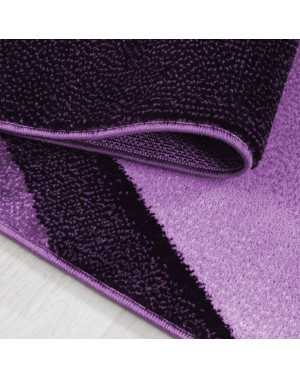 Modern abstract design vloerkleed met optische golven en korte pool, zwart, paars en wit.