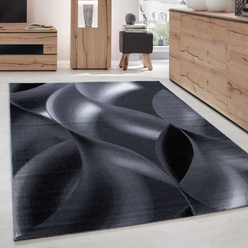 Modern design vloerkleed voor de woonkamer met korte pool en golvend patroon, zwart en grijs.